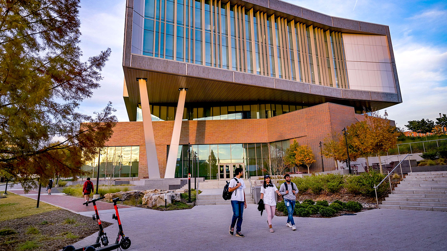 Students stroll together through Centennial Campus outside Fitts-Woolard Hall on a late afternoon in fall.