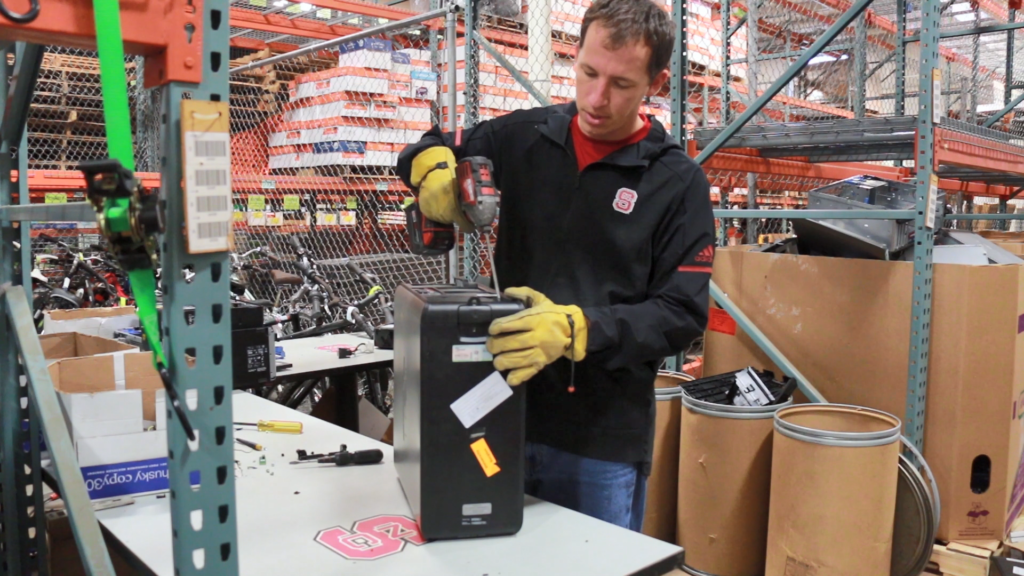 Central Receiving employee Lance reassembles surplus electronics for resale to divert landfill waste.