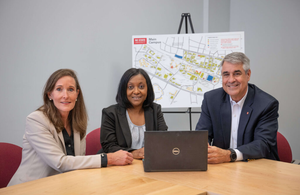 Catherine Philips, Missie Davis, Charles Maimone sit around a desk