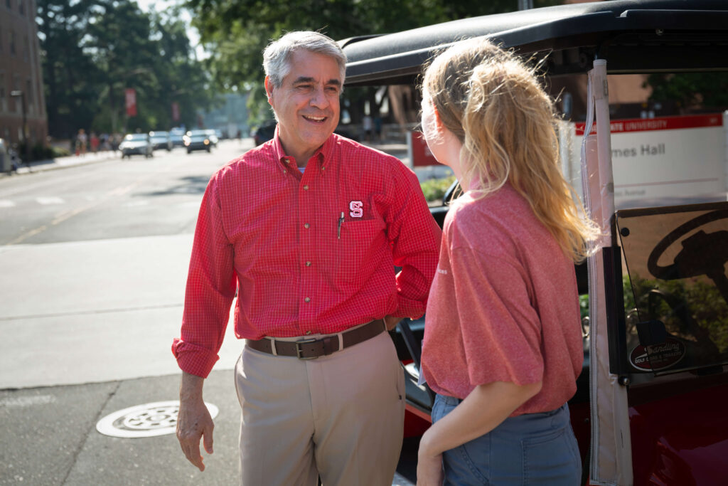 Charles Maimone welcomes a new student to NC State campus during move-in.